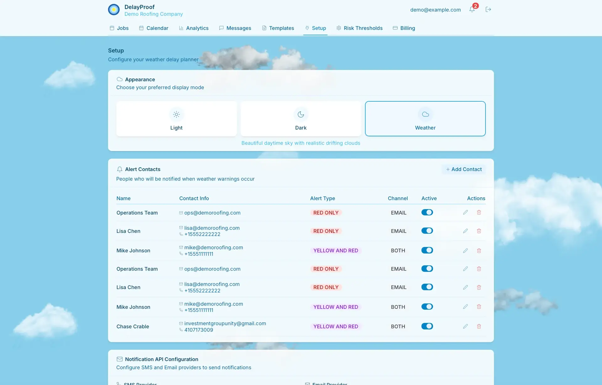 DelayProof Setup page in Weather theme with a daytime-sky cloud background, showing the appearance options and the Alert Contacts table.